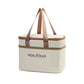 Cream thermal lunch bag with brown webbing handles and zippered lid, front logo