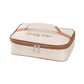 Cream insulated square lunch bag with brown zip trim and top handle loop, angled view
