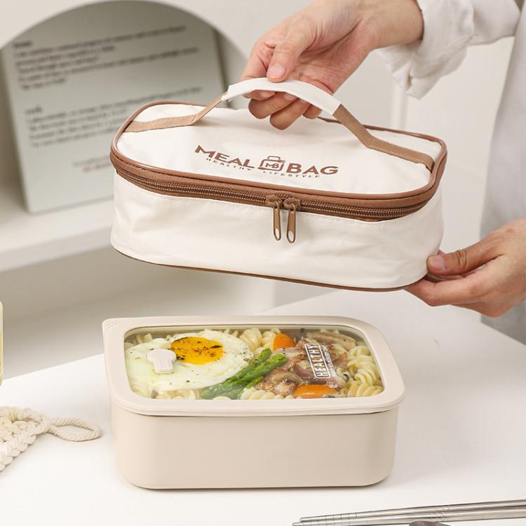 Cream insulated lunch bag with brown zipper, hands holding the open top compartment