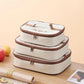 Stacked cream insulated lunch bags with brown zippers and handles, set shown