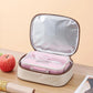 Cream insulated lunch bag opened, showing pink insert and silver-lined interior