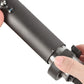 Hand holding a gray cylindrical cleaning brush attachment on a hair tool