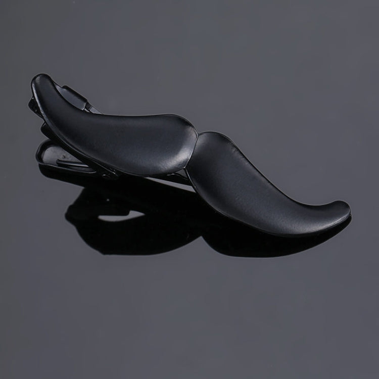 Black leather-look tie clip with curved top bar and spring clasp, glossy finish.