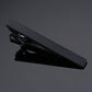 Black rectangular tie clip with minimal detailing and polished metal edges.