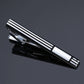 Silver-and-black striped tie clip with polished metal ends and engraved rectangular details.