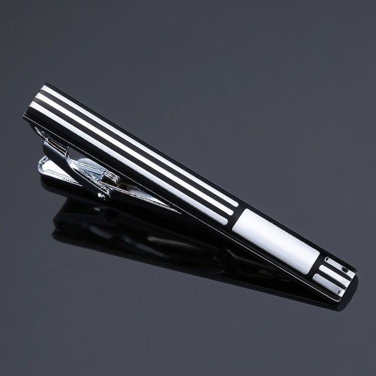 Silver-and-black striped tie clip with polished metal ends and engraved rectangular details.