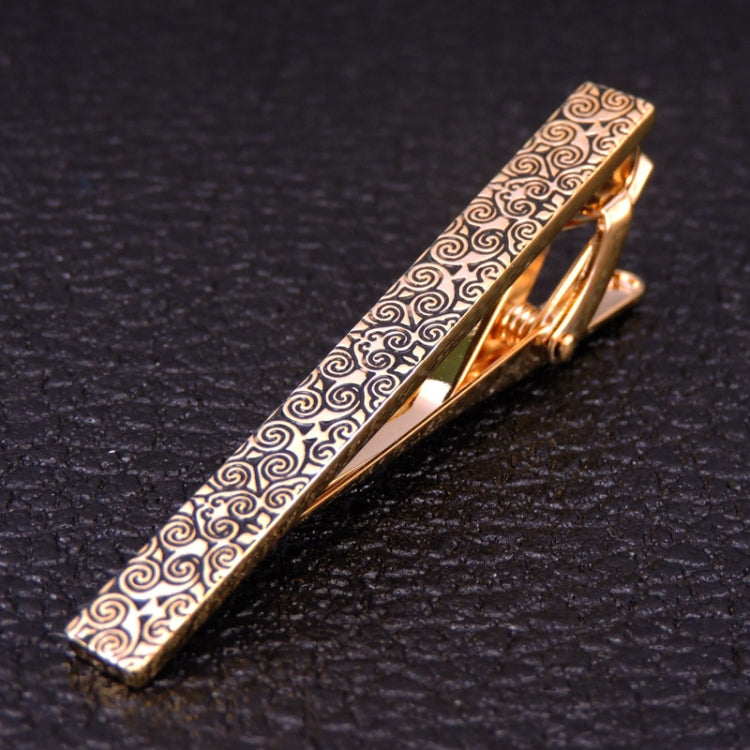 Gold-and-silver swirl patterned tie clip with hinged clasp