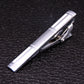 Silver tie clip with raised geometric lines and hinged clasp
