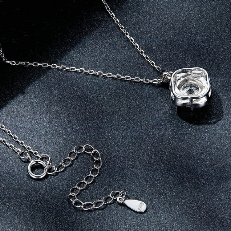Silver chain pendant close-up with round halo moissanite setting