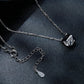 Silver-tone necklace clasp and chain links with small charm detail