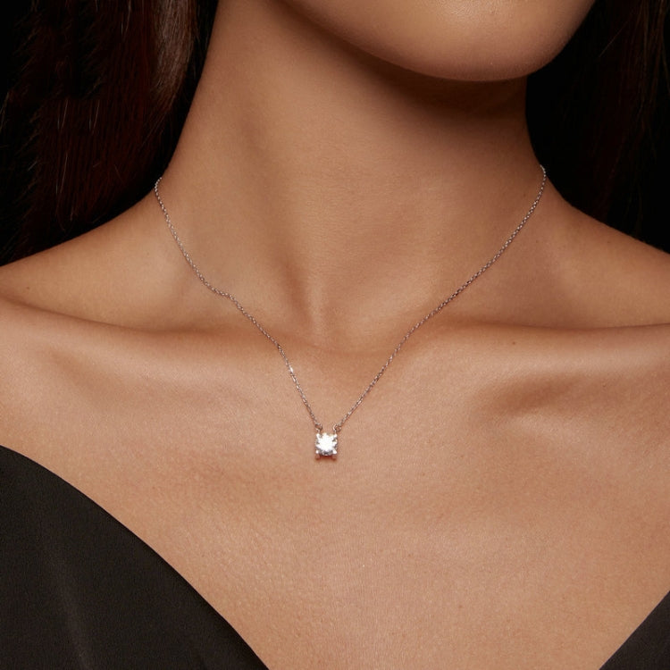 Moissanite pendant necklace with small square stone on fine chain, worn at neckline