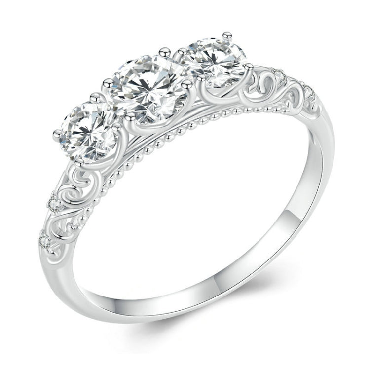 Sterling silver ring with engraved scroll band and five round moissanite-style stones