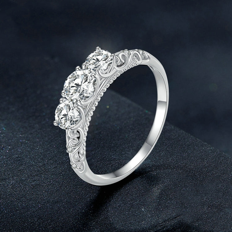 Sterling silver ring angled view with ornate filigree band and round moissanite-style stones