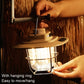 Green LED retro lantern with hanging ring, held by hand over hook point.