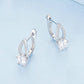 Silver hoop earrings with a teardrop halo and round clear zirconia center stone