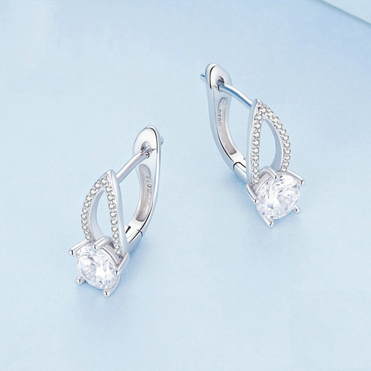 Silver hoop earrings with a teardrop halo and round clear zirconia center stone