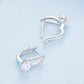 Back view of sterling silver hoop earrings with zirconia halo and hinged clasp