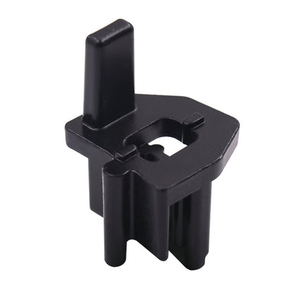 Black timing pulley tensioner mounting clip with central bolt hole opening