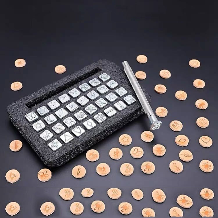 Leather punch stamp set with metal handle and square stamp punches on tray