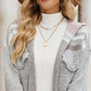 Grey hooded knit cardigan close-up with button pockets and patterned plaid fabric