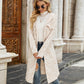 Cream hooded knit cardigan with textured stripe pattern and button front