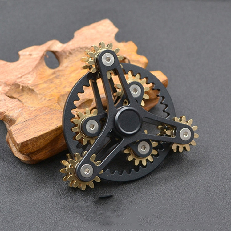 Black linkage fidget spinner toy with four gold gears and silver bearings