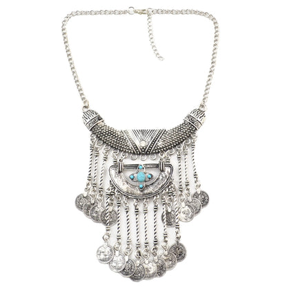 Tassel statement necklace with silver chain, ornate centerpiece, and blue turquoise accents