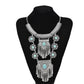 Silver-tone tassel statement necklace with turquoise cabochon and layered chain links