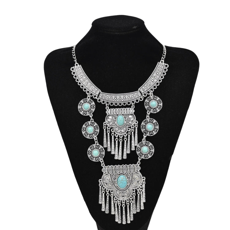 Silver-tone tassel statement necklace with turquoise cabochon and layered chain links