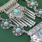 Silver-tone necklace with turquoise cabochon pendants and dangling tassel drops