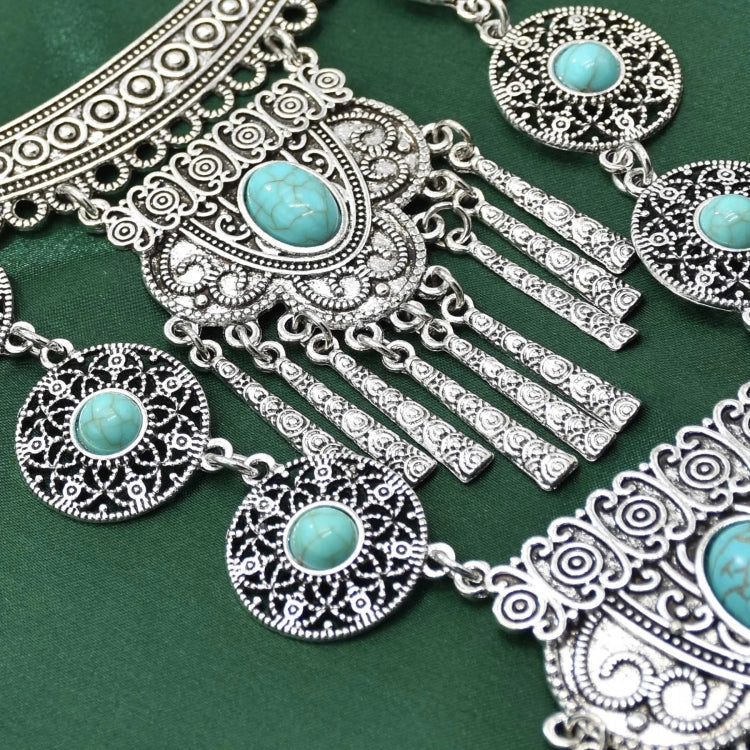 Silver-tone necklace with turquoise cabochon pendants and dangling tassel drops