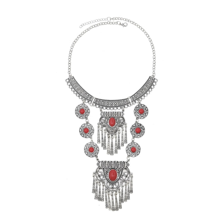 Tassel statement necklace with silver chain and red gemstone centerpiece with dangling charm drops