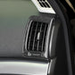 Close-up of black carbon-fiber air vent outlet trim bezel on dashboard