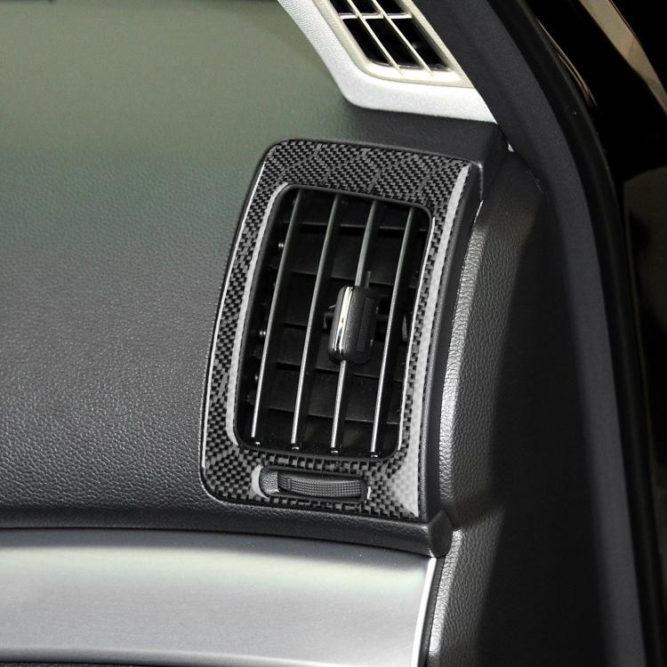 Close-up of black carbon-fiber air vent outlet trim bezel on dashboard