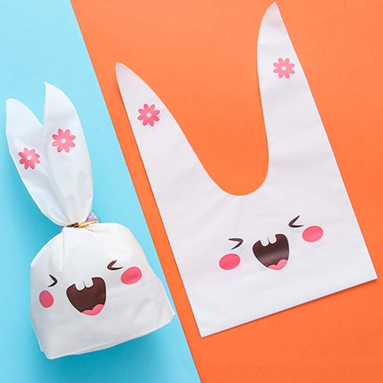 Rabbit-ear gift bag, white with pink flower accents and smiling cartoon bunny face.