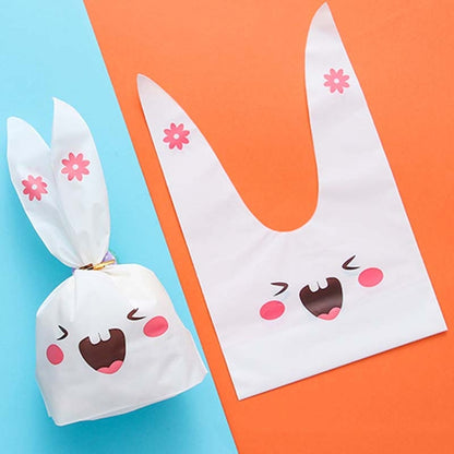 Rabbit-ear gift bag, white with pink flower accents and smiling cartoon bunny face.