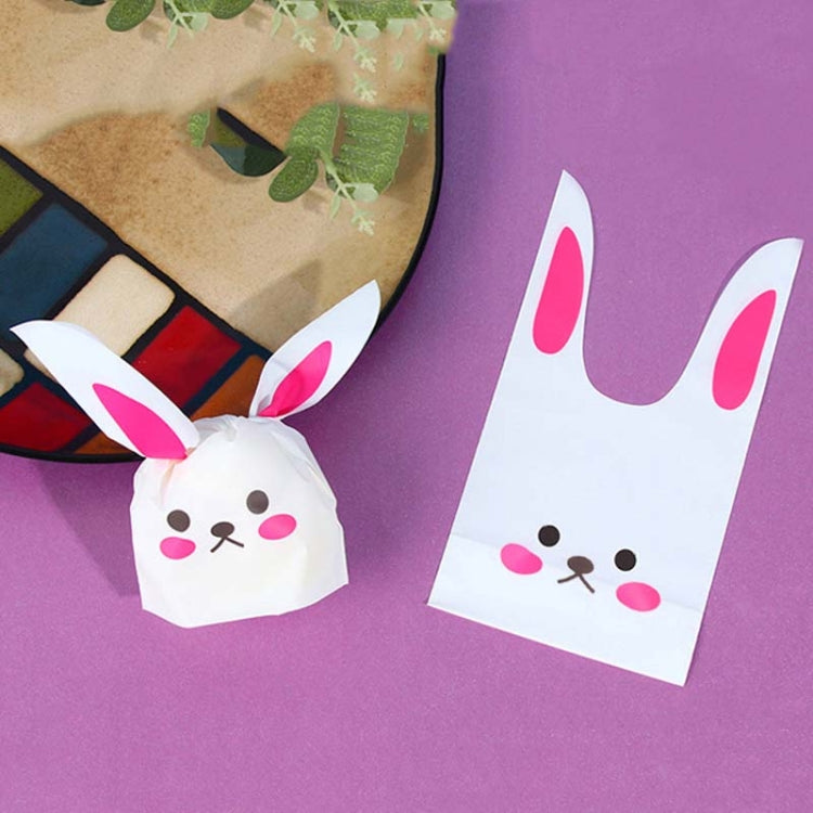 Rabbit-ear gift bag, white with pink ears and cartoon bunny face, tied closed.
