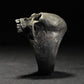 Silver-tone skull ring side view with cracked detailing and textured finish