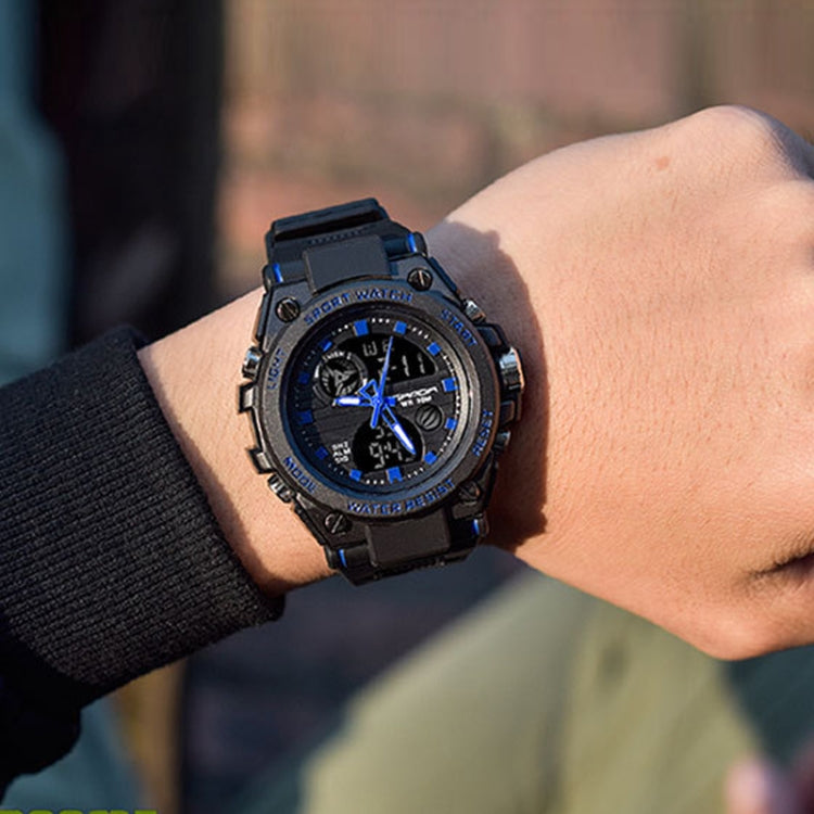 Waterproof sports watch on wrist, black strap and blue chronograph face