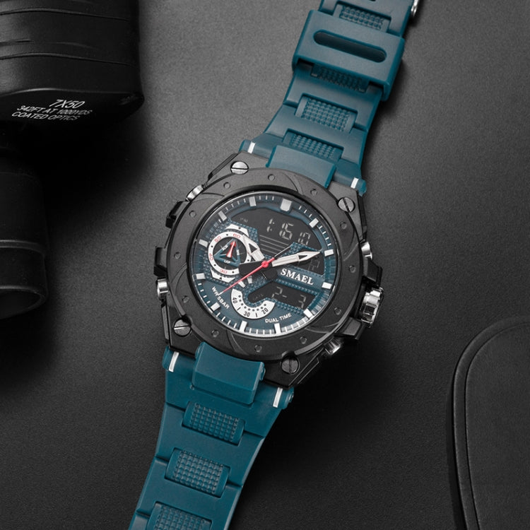 Men's sports alloy watch with blue rubber strap and dark dial from side angle