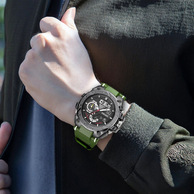 Men's sports watch worn on wrist with green rubber strap and dark dial