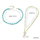 Turquoise bead and gold-tone necklace with rectangular charm pendant, linked chain style