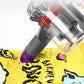 Vacuum suction nozzle brush head with red core and purple cup cleaning yellow fabric
