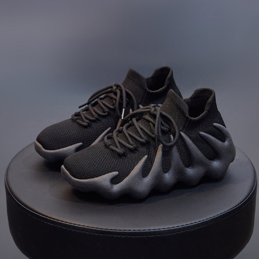 Black woven sock shoes with lace-up fronts and sculpted thick soles