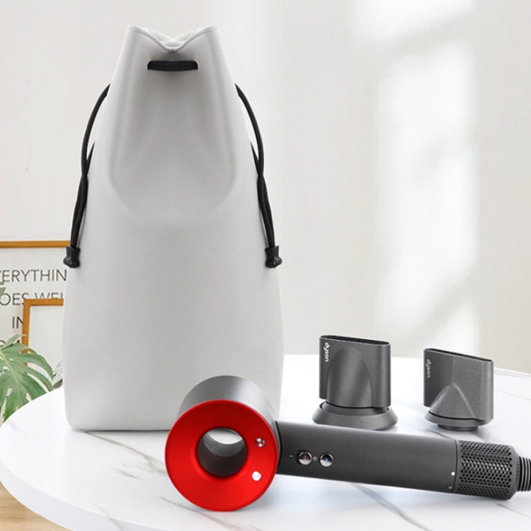 White storage bag with hair dryer and round red diffuser accessory on display.