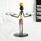 Man-shaped metal candleholder ornament with two trays, colorful coiled torso, base