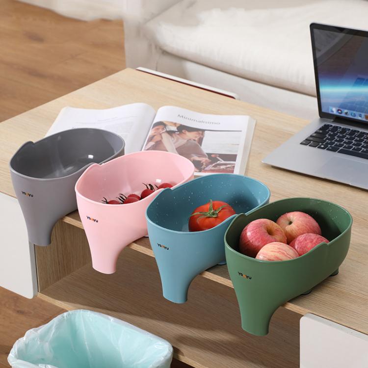 Elephant-shaped kitchen drain basket set in pink, gray, blue, and green on a table