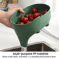 Green elephant-shaped drain basket on counter with red tomatoes and water draining