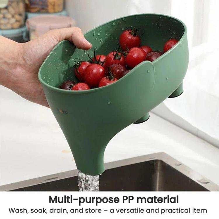 Green elephant-shaped drain basket on counter with red tomatoes and water draining