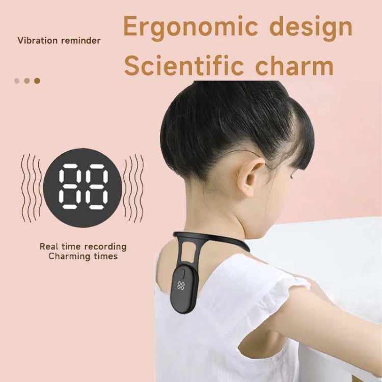 Black neck posture corrector worn on the back of a child’s neck
